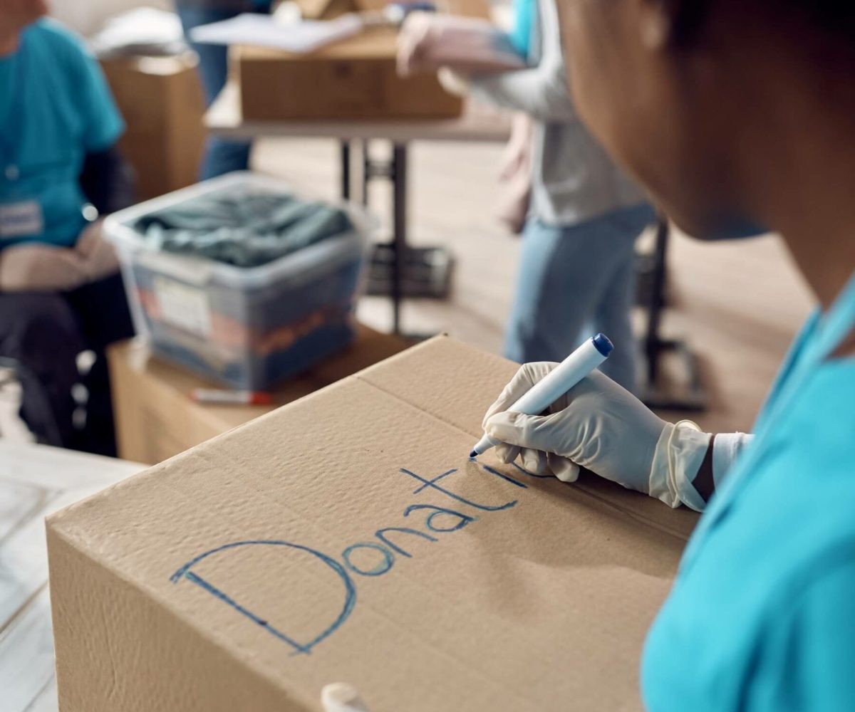 close-up-of-woman-marking-donation-boxes-while-vol-2022-11-16-14-40-42-utc.jpg